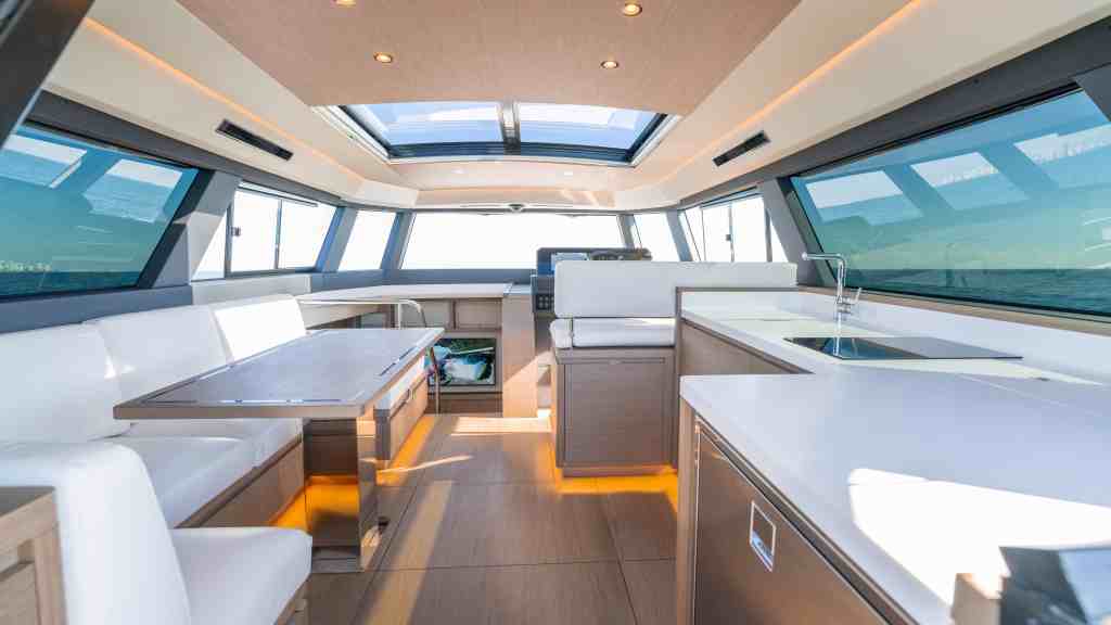 Luxury yacht interior with panoramic windows and modern furnishings.